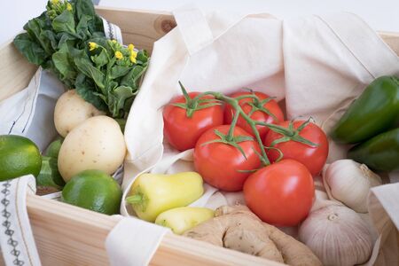 pine wood box and cotton eco bag with fresh vegetables .plastic free for groceries product shopping and delivery. zero waste lifestyle .の写真素材