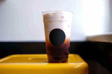 ice thai tea in the plastic cup.