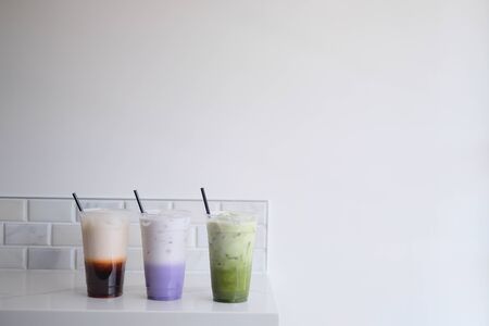 thai tea, taro milk tea, matcha green tea on the white background. cold refreshment drink beverage concept.の写真素材