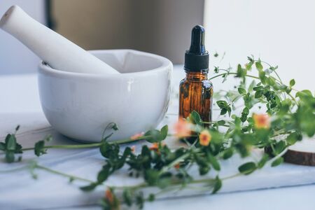 natural skincare on marble background with flower, leaf and pestle mortar . cosmetic beauty background.の写真素材