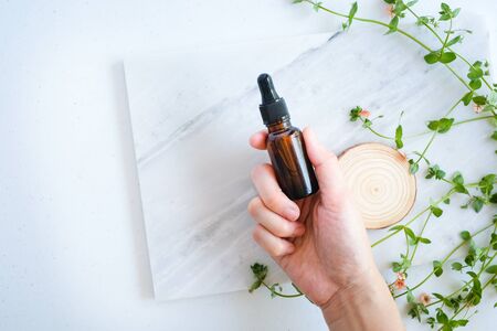 natural skincare on marble background with flower, leaf and pestle mortar . cosmetic beauty background.の写真素材
