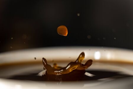 coffee splash and drop . macro close up brown liquid with smoke.