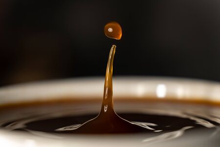 coffee splash and drop . macro close up brown liquid with smoke.の写真素材