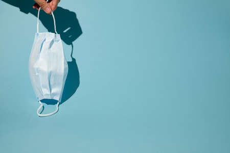 hand hold surgical face mask for new normal life.の写真素材