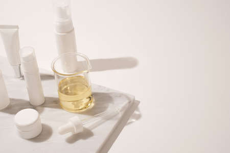 cosmetic and skin care for beauty routine on white background with shadow. modern and minimal product design with essential oil, pestle and mortar.の写真素材