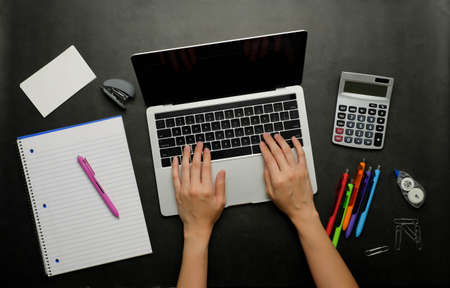 the person analyzing financial data.office and study stationery with a laptop for online work and back to school.の写真素材