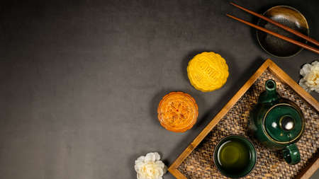 Moon cake with tea. Chinese celebration and asian tradition. Baked oriental pastry for mid autumn.