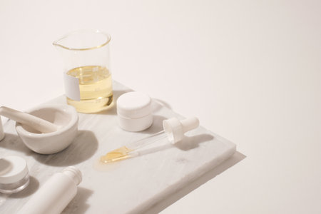 cosmetic and skin care for beauty routine on white background with shadow. modern and minimal product design with essential oil, pestle and mortar.の写真素材