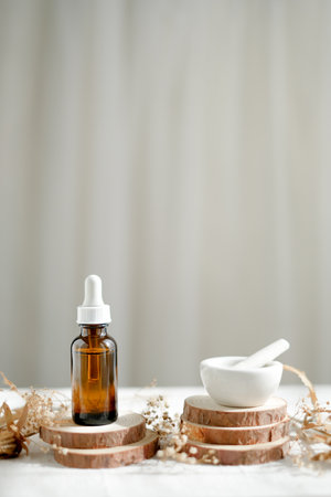 skincare serum with natural wooden stand and small pestle and mortar on white background.の写真素材