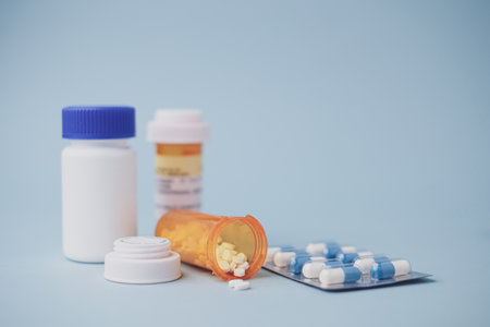 Medicine and container for health care medical and pharmacy concept on blue background.の写真素材