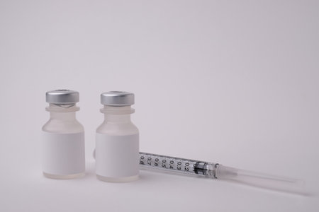the needle and syringe with the vaccine vial for injection and pharmacy concept. Medical and health care prevention for disease and COVID-19.の写真素材