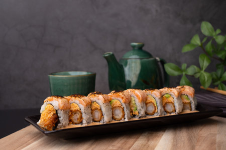 tempura sushi roll topped with seared salmon and serve with hot tea. Japanese traditional dishes and healthy food.の写真素材