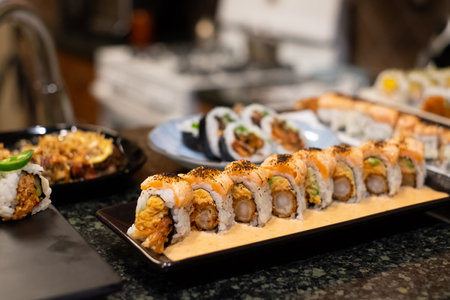 tempura sushi roll topped with seared salmon and serve with hot tea. Japanese traditional dishes and healthy food.の写真素材