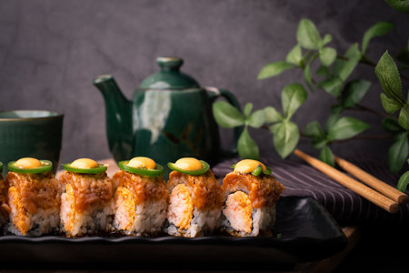 tempura sushi roll topped with seared salmon and serve with hot tea. Japanese traditional dishes and healthy food. homed cookingの写真素材