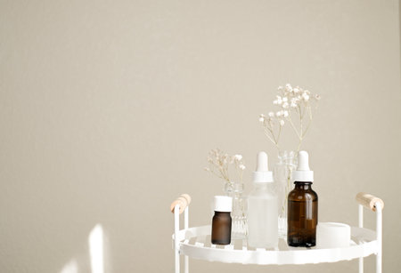 The natural skincare products with white flower is on the white shelf in the bathroom for spa,self-care, and beauty concept. Selective focusの写真素材