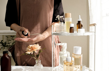 The woman pours oil on her skin. Skincare routine and self-care concept. the beauty care and wellness lifestyle.の写真素材