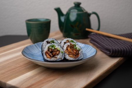 sushi roll with hot tea pot. Japanese healthy food and gourmet dish concept.の写真素材
