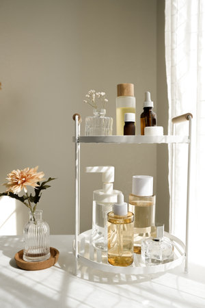 The beauty product and skincare set on the bath shelf with luxury flowers and a mirror for the spa concept.の写真素材
