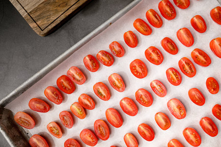 The abstract background represent nutrition and nutrient or vitamin from fruit and vegetable. Cut tomato on the tray for baking.の写真素材