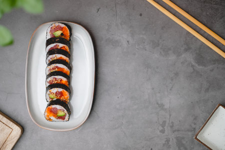 Top view of sushi rolls of tuna, cucumber, and avocado with copy space of the black concrete table.の写真素材