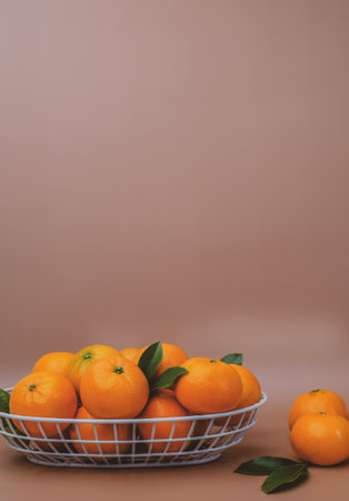 the vertical view of orange in the basket on orange background. copy spaceの写真素材