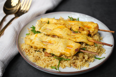 Chicken skewers over spice curry basmati rice.の写真素材