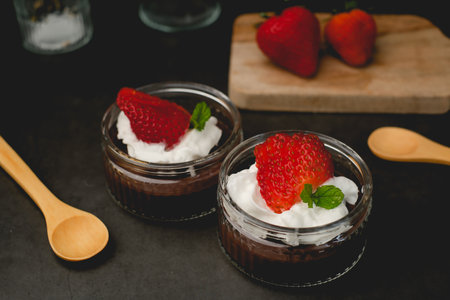 Chocolate pudding with cream and strawberry. Sweet dessert and home cooking. vertical