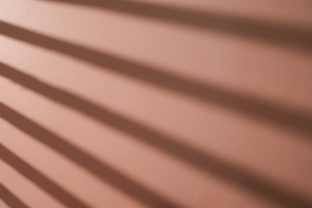 sun shade, sun light through the window on orange background for summer background,の写真素材