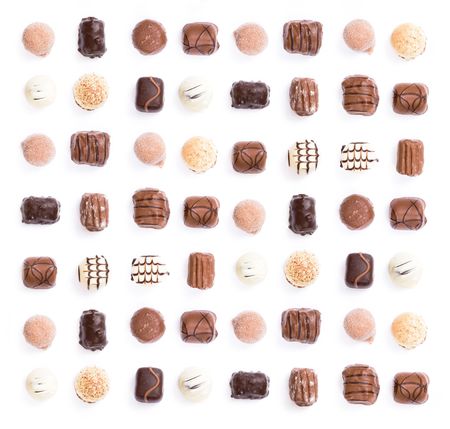 Chocolates in a uniform pattern isolated on whiteの写真素材