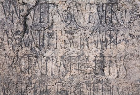 Roman engraved writing on ancient weathered stoneの写真素材