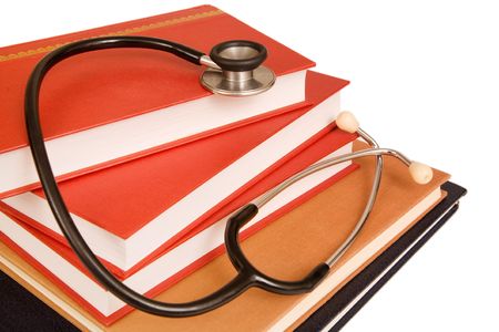 Stethoscope on a stack of reference books isolated on whiteの写真素材