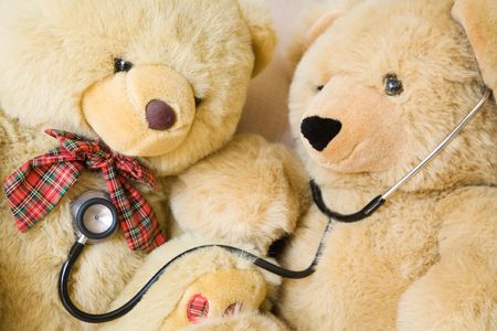 Teddy bears with stethoscope posing as doctor and patient. Ideal to illustrate paediatrics.の写真素材