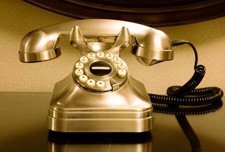 Traditional, vintage rotary style telephone on a deskの写真素材
