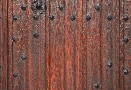 Closeup of a traditional wooden door with cast iron studsの写真素材