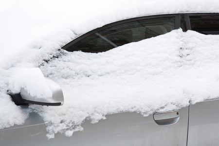 Closeup of a car covered in snowの写真素材