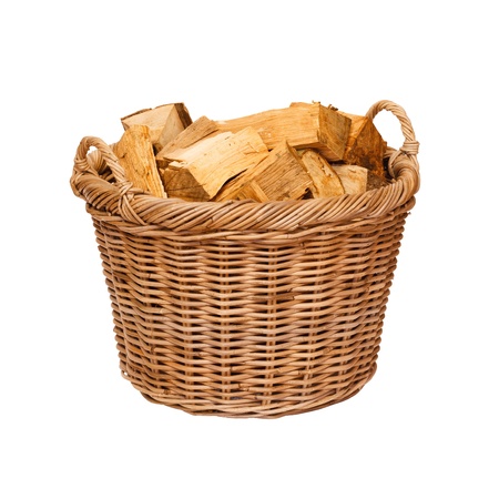 Traditional wicker log basket with oak logs isolated against a white backgroundの写真素材