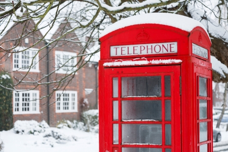 Old English red phone box in winter sceneの写真素材