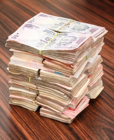 Stack of Indian rupees on a tableの写真素材