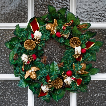 Close up of festive Christmas wreath hanging on a doorの写真素材