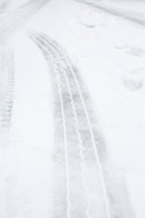 Tyre tracks on ice and snow on a highwayの写真素材