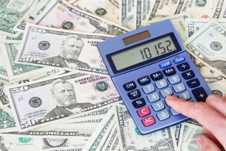 Financial background of dollar notes with a calculatorの写真素材