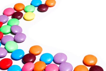 Colorful candy arranged in a pattern on a white background with copy spaceの写真素材
