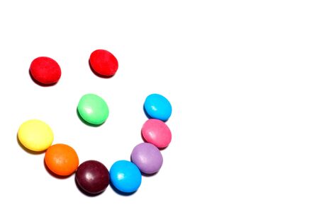 Colorful candy smiley face on a white background with copy spaceの写真素材