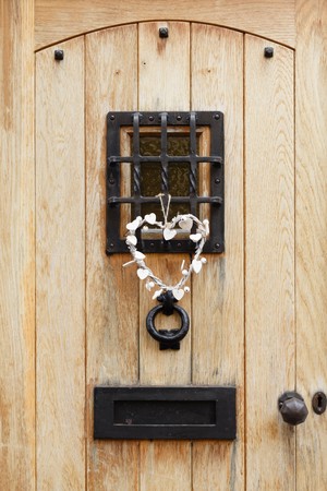 Traditional wooden front door of a house with ironmongeryの写真素材