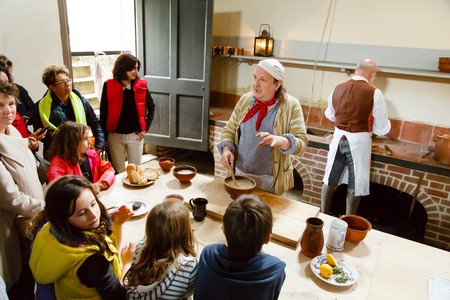 LONDON - CIRCA 2014: Chefs in traditional dress demonstrate cookery at the Royal Kitchens, Kew Gardens, London, UKのeditorial素材