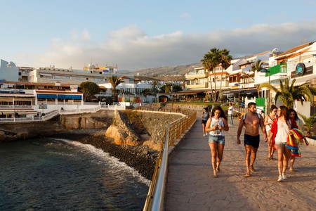 TENERIFE, SPAIN - CIRCA 2015: Spanish tourists walk along the seafront in La Caleta, Tenerife, Canary Islandsのeditorial素材