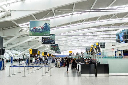 LONDON, UK - CIRCA 2017: Passengers queue for check in at the departure hall in Terminal 5, Heathrow Airportのeditorial素材