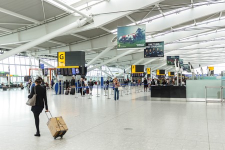 LONDON, UK - CIRCA 2017: A female passenger arrives for checkin at the departure hall in Terminal 5, Heathrow Airportのeditorial素材