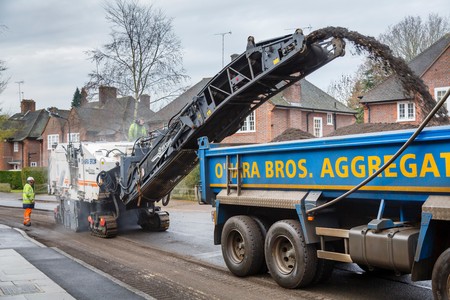 LONDON, UK - CIRCA 2013: Roadworks to resurface the tarmac of a residential road in London, UKのeditorial素材