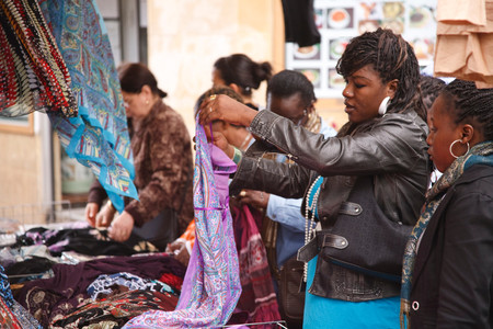 PARIS, FRANCE - CIRCA 2009: French women of African ethnicity browse a market stall in Quartier Bellevilleのeditorial素材